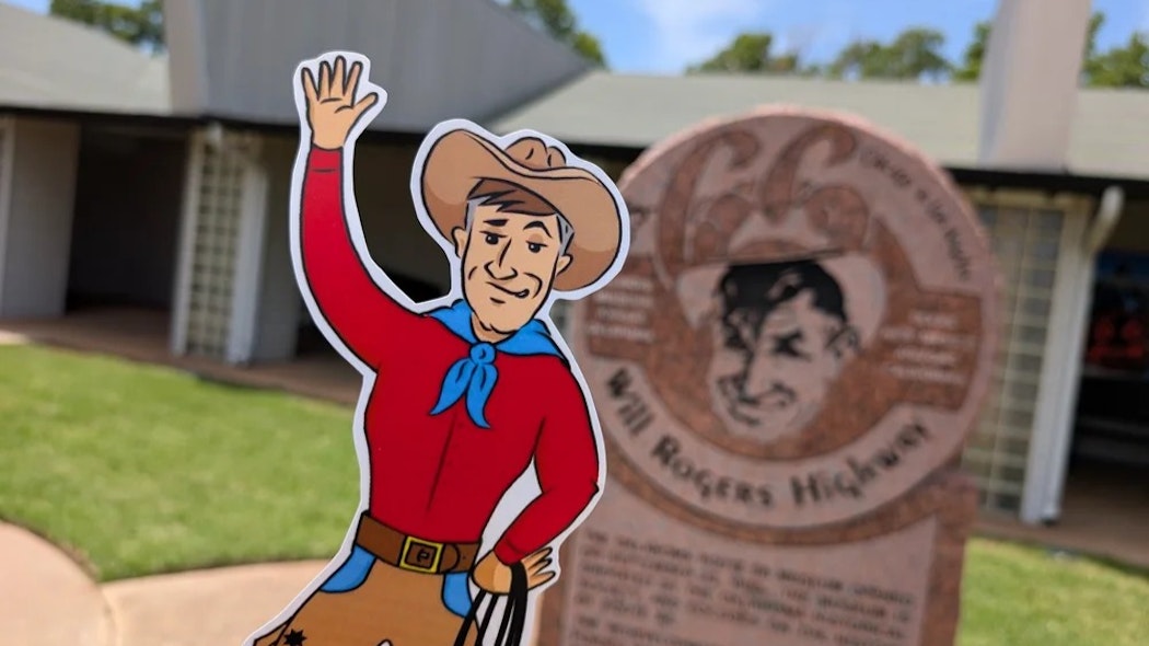 Flat Will in front of Will Rogers Highway historical marker