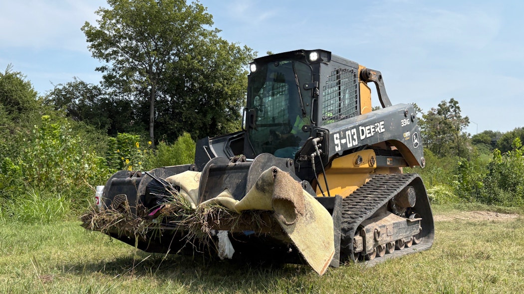 Loader moves debris from homeless camp